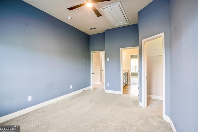 2604 Heltonwood Ct, Buford, GA 30519 - unfurnished bedroom featuring attic access, light carpet, a walk in closet, baseboards, and a closet