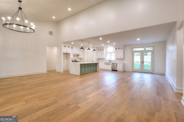 1947 Clark Dr, Tucker, GA 30084 - unfurnished living room with french doors, a chandelier, light wood-style flooring, baseboards, and recessed lighting
