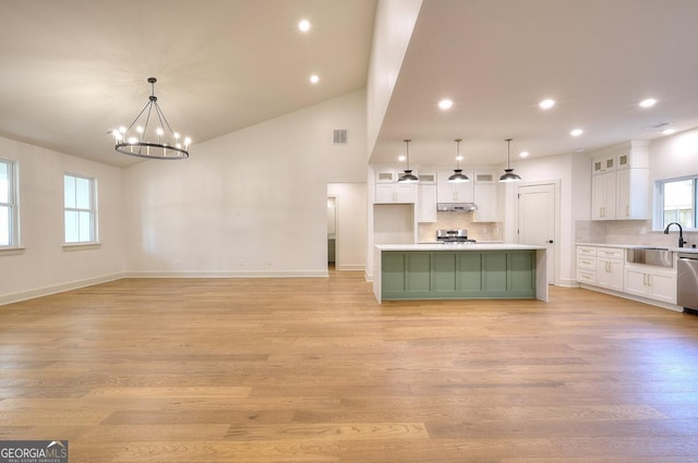 1947 Clark Dr, Tucker, GA 30084 - kitchen with dishwasher, under cabinet range hood, white cabinets, a sink, and range