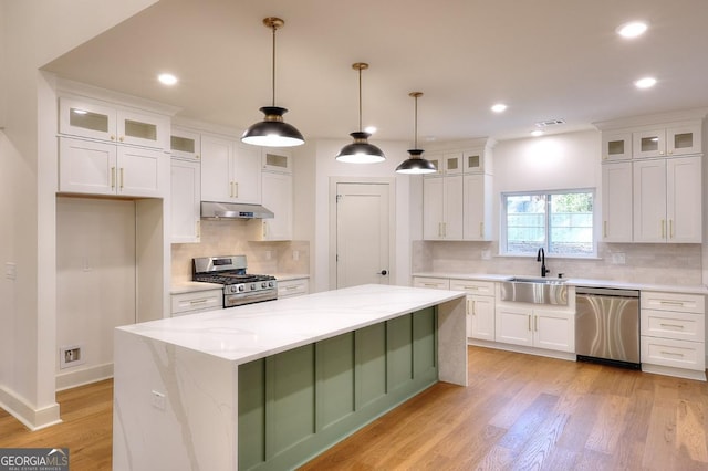 1947 Clark Dr, Tucker, GA 30084 - kitchen featuring stainless steel appliances, a sink, under cabinet range hood, white cabinets, and recessed lighting