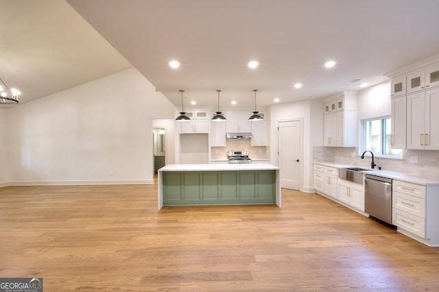 1947 Clark Dr, Tucker, GA 30084 - kitchen with appliances with stainless steel finishes, a sink, under cabinet range hood, white cabinetry, and backsplash