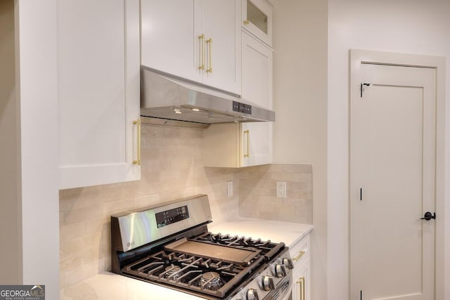 1947 Clark Dr, Tucker, GA 30084 - kitchen featuring stainless steel gas stove, under cabinet range hood, white cabinets, decorative backsplash, and light countertops