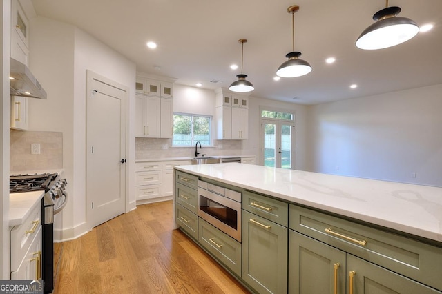 1947 Clark Dr, Tucker, GA 30084 - kitchen with stainless steel appliances, a sink, light wood-style flooring, white cabinets, and decorative backsplash