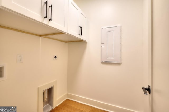 1947 Clark Dr, Tucker, GA 30084 - laundry area with baseboards, cabinet space, electric dryer hookup, electric panel, and light wood-type flooring