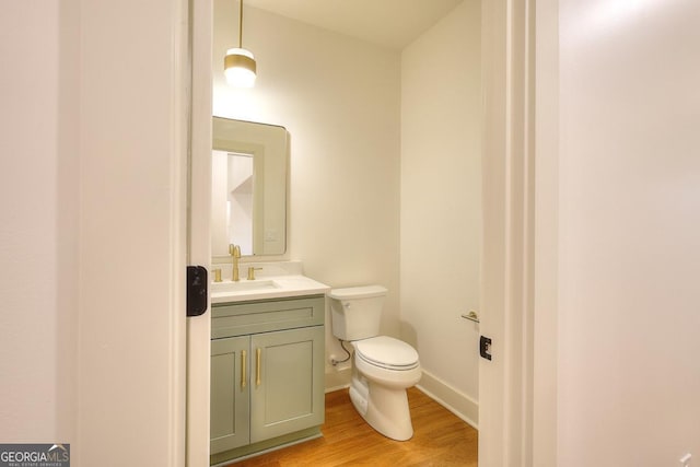 1947 Clark Dr, Tucker, GA 30084 - half bath with vanity, toilet, wood finished floors, and baseboards