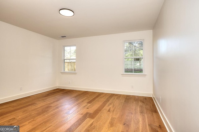 1947 Clark Dr, Tucker, GA 30084 - empty room with plenty of natural light, light wood-type flooring, and baseboards