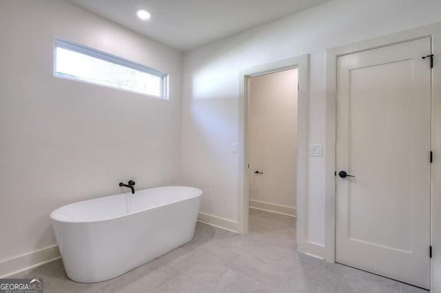 1947 Clark Dr, Tucker, GA 30084 - bathroom with a freestanding bath and baseboards