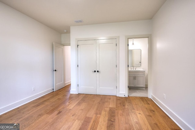 1947 Clark Dr, Tucker, GA 30084 - unfurnished bedroom featuring light wood-type flooring, baseboards, a closet, and ensuite bathroom