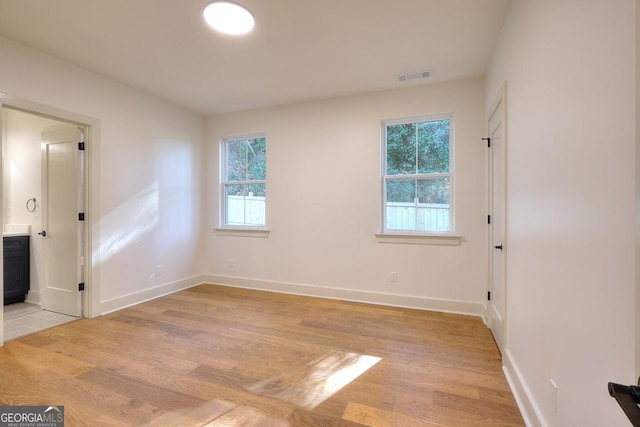 1947 Clark Dr, Tucker, GA 30084 - unfurnished bedroom with light wood-type flooring, baseboards, and connected bathroom