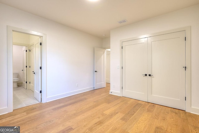 1947 Clark Dr, Tucker, GA 30084 - unfurnished bedroom with light wood-style flooring, a closet, ensuite bath, and baseboards