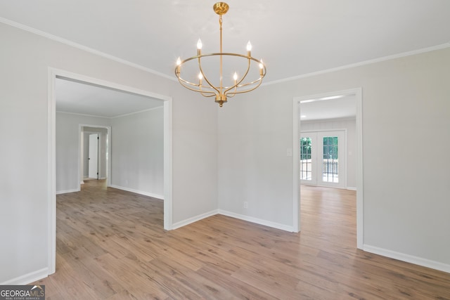 1173 Normandy Rd, Macon, GA 31210 - spare room featuring a chandelier, light wood finished floors, ornamental molding, and baseboards
