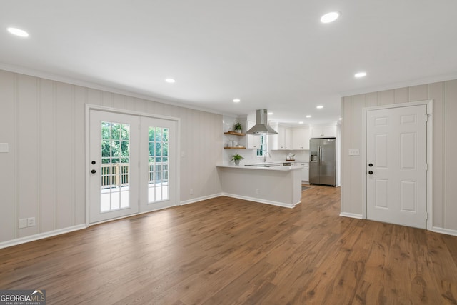 1173 Normandy Rd, Macon, GA 31210 - kitchen featuring stainless steel refrigerator with ice dispenser, ornamental molding, island range hood, a peninsula, and light countertops