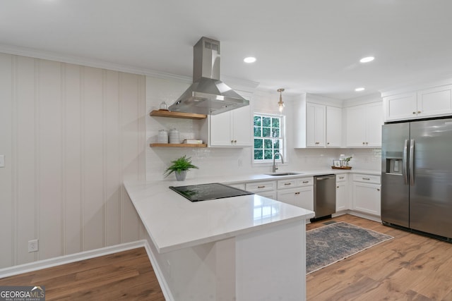1173 Normandy Rd, Macon, GA 31210 - kitchen with appliances with stainless steel finishes, island range hood, a sink, wood finished floors, and crown molding