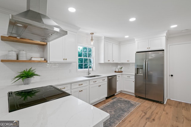 1173 Normandy Rd, Macon, GA 31210 - kitchen featuring appliances with stainless steel finishes, island exhaust hood, a sink, white cabinetry, and light wood-style flooring