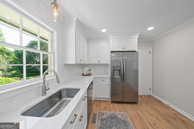 1173 Normandy Rd, Macon, GA 31210 - kitchen with stainless steel appliances, a sink, backsplash, white cabinetry, and light countertops