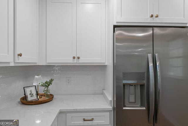 1173 Normandy Rd, Macon, GA 31210 - kitchen featuring stainless steel fridge, white cabinets, and tasteful backsplash
