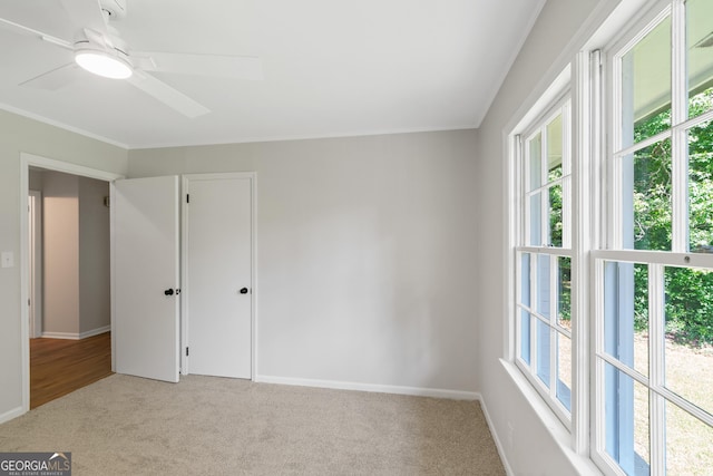 1173 Normandy Rd, Macon, GA 31210 - unfurnished bedroom with light carpet, ornamental molding, baseboards, and ceiling fan