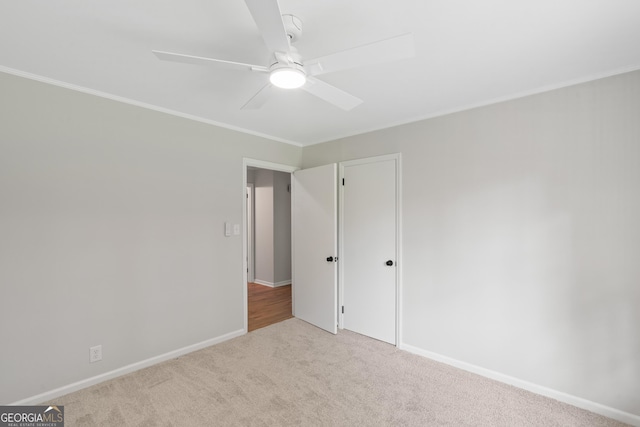 1173 Normandy Rd, Macon, GA 31210 - unfurnished bedroom featuring light carpet, crown molding, baseboards, a ceiling fan, and a closet