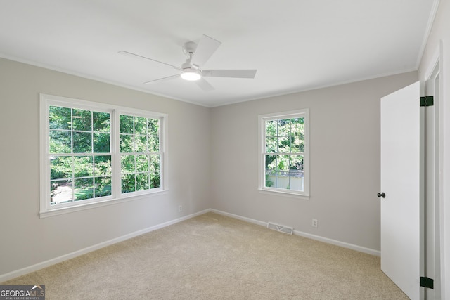 1173 Normandy Rd, Macon, GA 31210 - empty room featuring crown molding, light carpet, baseboards, and ceiling fan