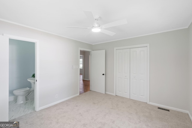 1173 Normandy Rd, Macon, GA 31210 - unfurnished bedroom featuring crown molding, a closet, baseboards, ensuite bathroom, and carpet flooring