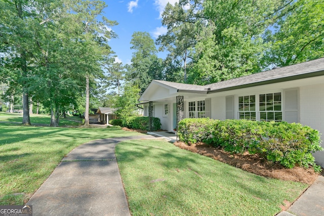 1173 Normandy Rd, Macon, GA 31210 - ranch-style home with a front yard, brick siding, and a shingled roof