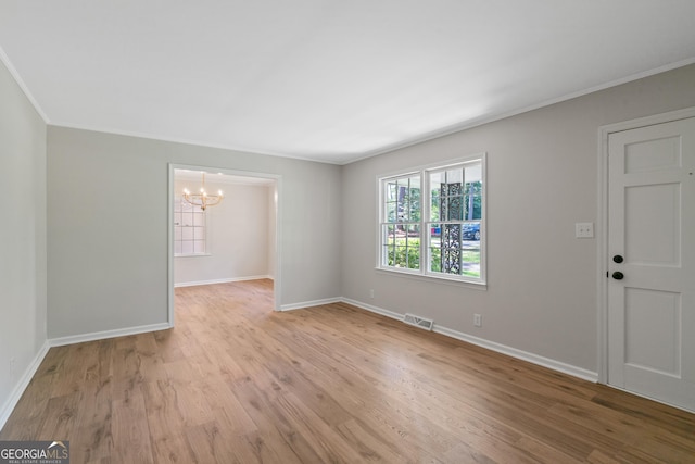 1173 Normandy Rd, Macon, GA 31210 - spare room with a chandelier, light wood-type flooring, baseboards, and crown molding