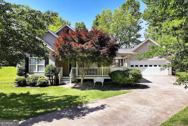 145 Charles Dr, Cleveland, GA 30528 - view of property hidden behind natural elements with driveway, a front lawn, an attached garage, and covered porch