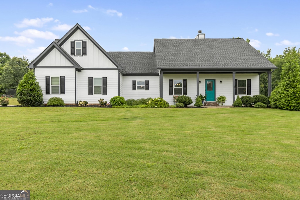 163 Stillmeadow Dr, Commerce, GA 30529 - view of front of property with a front lawn, board and batten siding, roof with shingles, and a chimney