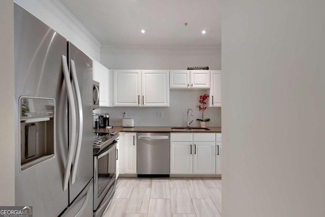 1850 Cotillion Dr Unit 2304, Atlanta, GA 30338 - kitchen featuring appliances with stainless steel finishes, a sink, white cabinets, backsplash, and crown molding
