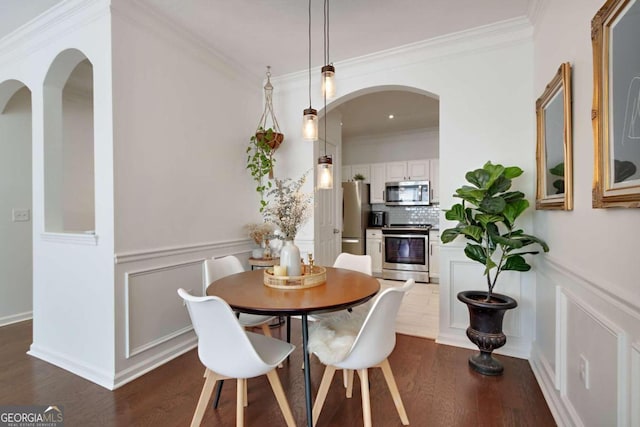 1850 Cotillion Dr Unit 2304, Atlanta, GA 30338 - dining room with ornamental molding, dark wood-style flooring, arched walkways, a decorative wall, and a wainscoted wall