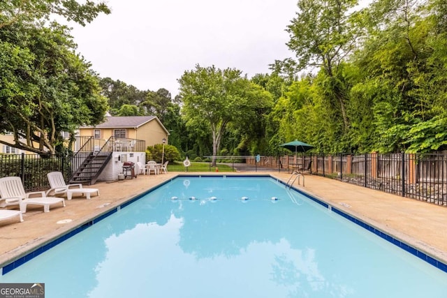 1701 Wiscasset Pl, Tucker, GA 30084 - community pool with stairs, a patio, and view of scattered trees