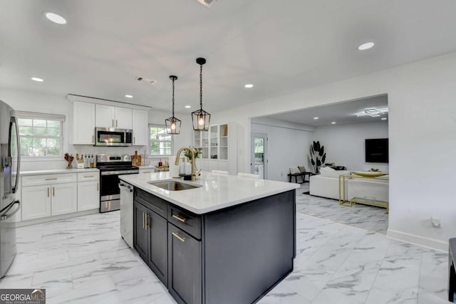 3799 Sweetbriar Cir, Lithia Springs, GA 30122 - kitchen featuring stainless steel appliances, a sink, white cabinets, plenty of natural light, and recessed lighting