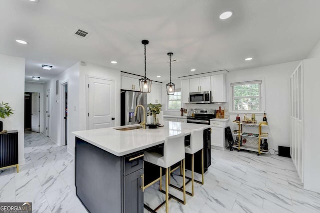 3799 Sweetbriar Cir, Lithia Springs, GA 30122 - kitchen with appliances with stainless steel finishes, white cabinets, light countertops, light marble finish flooring, and recessed lighting