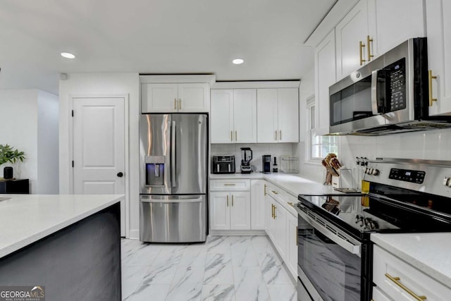 3799 Sweetbriar Cir, Lithia Springs, GA 30122 - kitchen with stainless steel appliances, recessed lighting, light countertops, white cabinetry, and light marble finish flooring