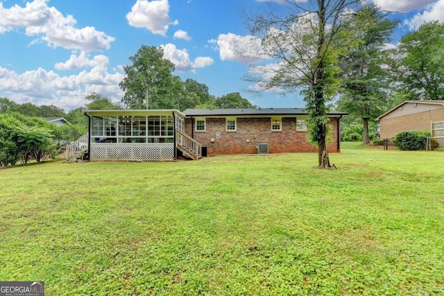 3799 Sweetbriar Cir, Lithia Springs, GA 30122 - back of property with a sunroom, cooling unit, a yard, brick siding, and stairs