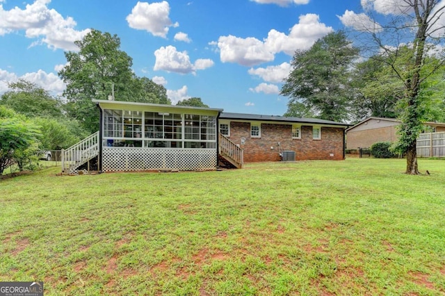 3799 Sweetbriar Cir, Lithia Springs, GA 30122 - rear view of property with stairway, a sunroom, central AC unit, and brick siding
