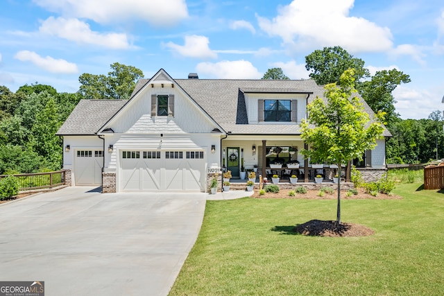 21 Little Creek Dr, Monroe, GA 30655 - modern farmhouse style home featuring covered porch, driveway, a shingled roof, a garage, and a chimney