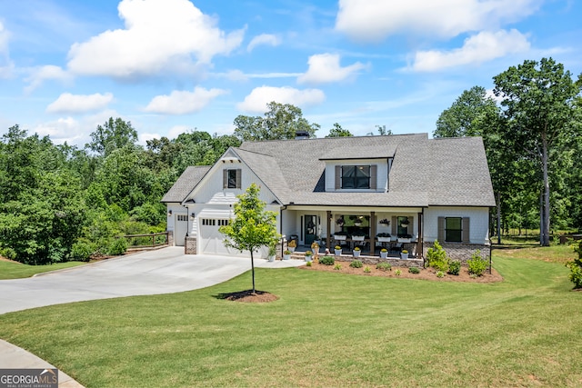 21 Little Creek Dr, Monroe, GA 30655 - modern farmhouse style home featuring a porch, concrete driveway, a front lawn, and roof with shingles
