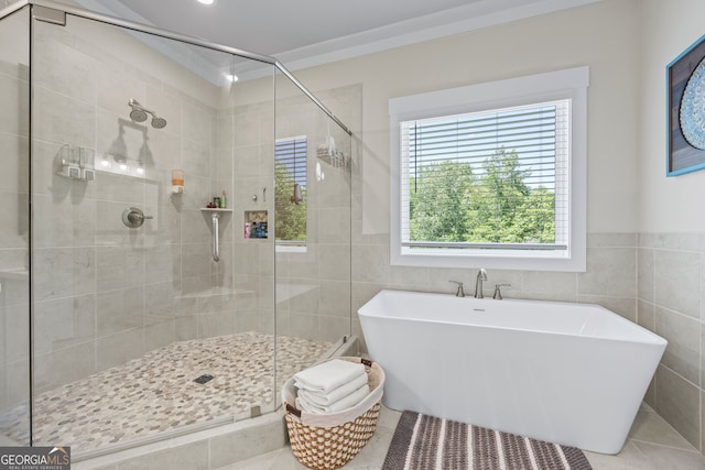 21 Little Creek Dr, Monroe, GA 30655 - bathroom with a soaking tub, a shower stall, tile walls, and tile patterned floors