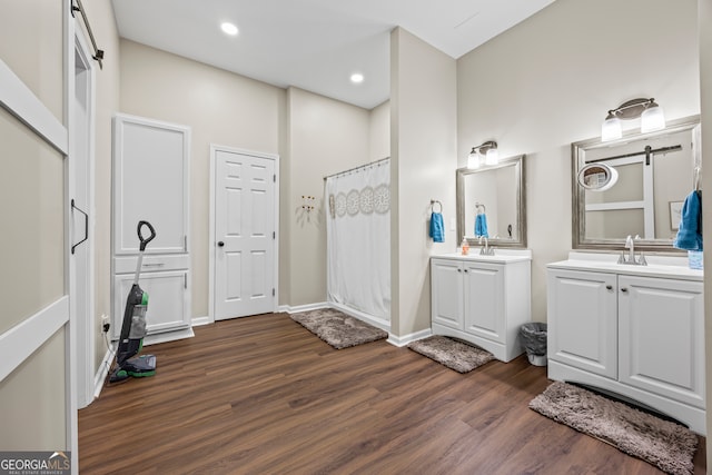 21 Little Creek Dr, Monroe, GA 30655 - bathroom featuring wood finished floors, two vanities, a shower with curtain, and recessed lighting