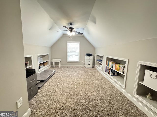 1761 Turtle Pond Dr, Watkinsville, GA 30677 - living area featuring built in shelves, carpet flooring, lofted ceiling, a ceiling fan, and baseboards