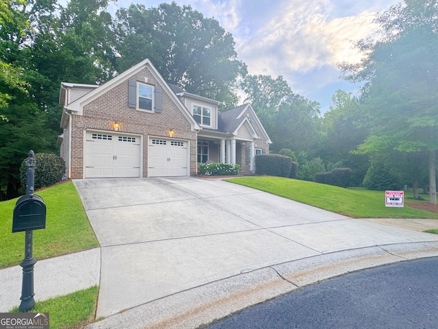 1761 Turtle Pond Dr, Watkinsville, GA 30677 - view of front of house featuring brick siding, concrete driveway, a front lawn, and a garage