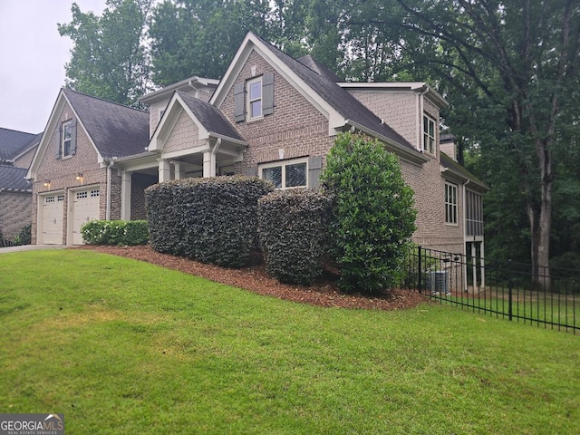 1761 Turtle Pond Dr, Watkinsville, GA 30677 - view of front of home featuring central AC unit, brick siding, a garage, and driveway