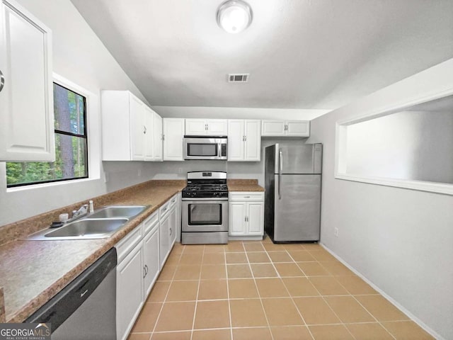 3924 Chimney Ridge Ct, Ellenwood, GA 30294 - kitchen featuring appliances with stainless steel finishes, a sink, white cabinetry, light tile patterned floors, and baseboards