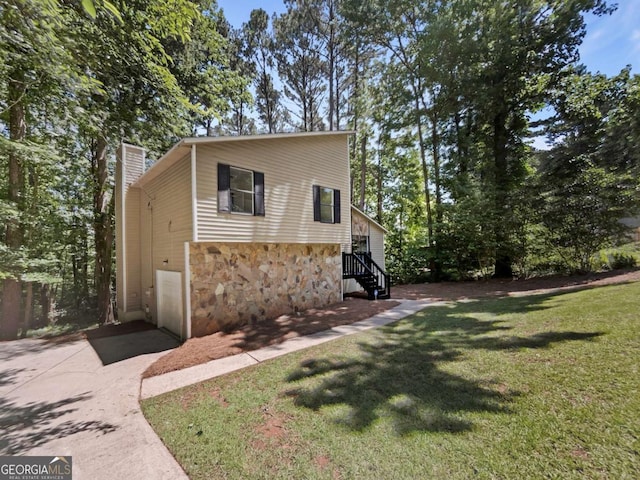 3924 Chimney Ridge Ct, Ellenwood, GA 30294 - view of front facade featuring stone siding, a front yard, and a chimney