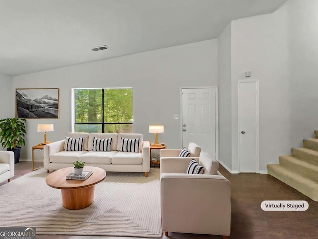 3924 Chimney Ridge Ct, Ellenwood, GA 30294 - carpeted living room with lofted ceiling, baseboards, and stairway