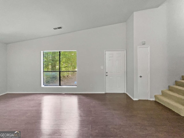 3924 Chimney Ridge Ct, Ellenwood, GA 30294 - empty room featuring baseboards, stairway, dark wood-style flooring, and high vaulted ceiling