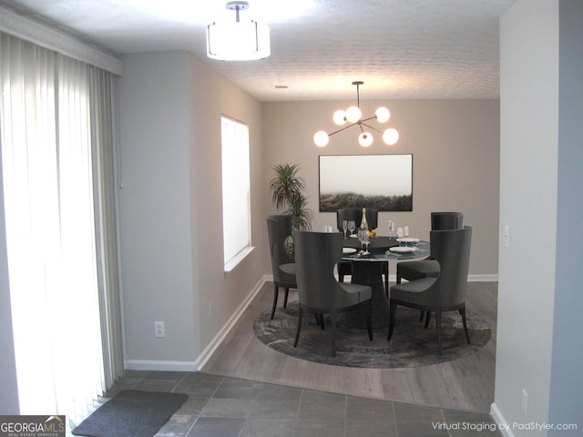 4383 Chestnut Lake Ave, Lithonia, GA 30038 - tiled dining room featuring a chandelier and baseboards