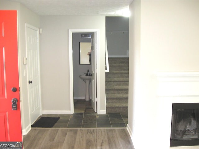 4383 Chestnut Lake Ave, Lithonia, GA 30038 - corridor featuring stairway, wood finished floors, baseboards, and a sink