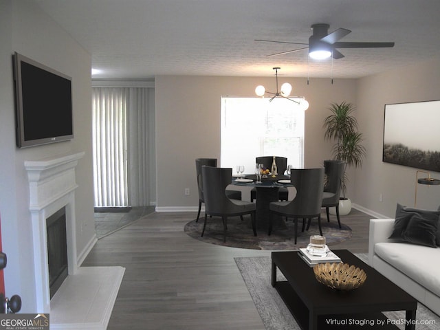 4383 Chestnut Lake Ave, Lithonia, GA 30038 - living area with a fireplace with raised hearth, a chandelier, wood finished floors, and ceiling fan
